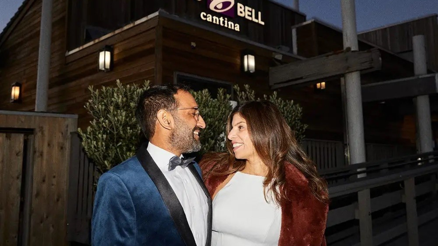 Sheel Mohnot and Amruta Godbole in front of a real-world Taco Bell. Taco Bell